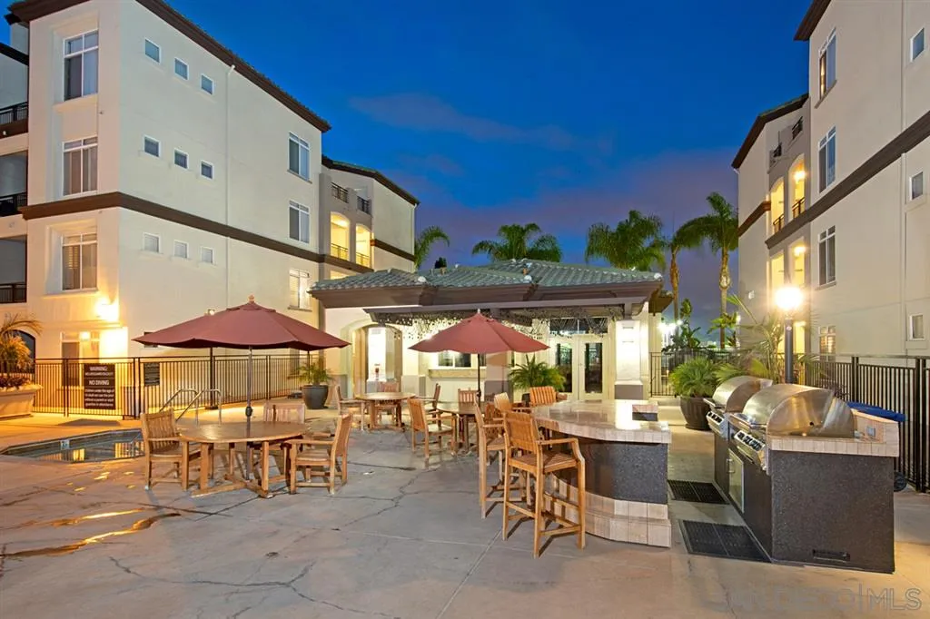 9237 Regents Road, Unit K401 La Jolla, CA 92037 - Photo 6 of 25 a view of a tables and chairs under an umbrella in front of building