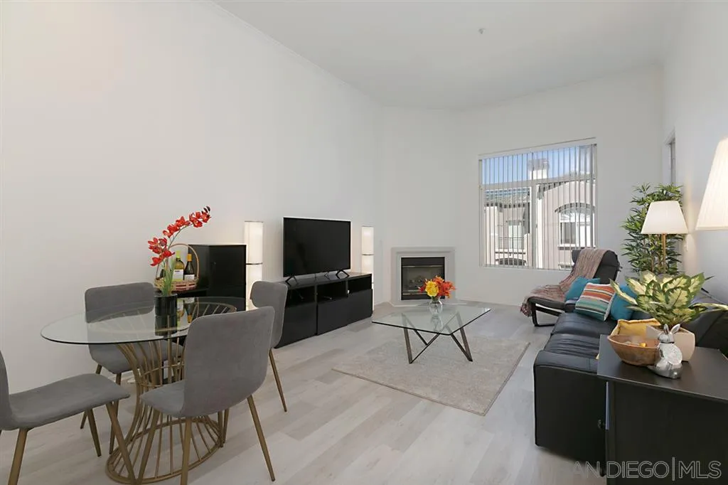 9237 Regents Road, Unit K401 La Jolla, CA 92037 - Photo 10 of 25 a living room with furniture a flat screen tv and a window
