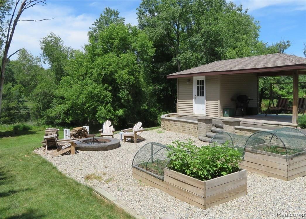8705 Tindall Road Davisburg, MI 48350 - Photo 54 of 68 Backyard planters and fire ring, garden house, pond