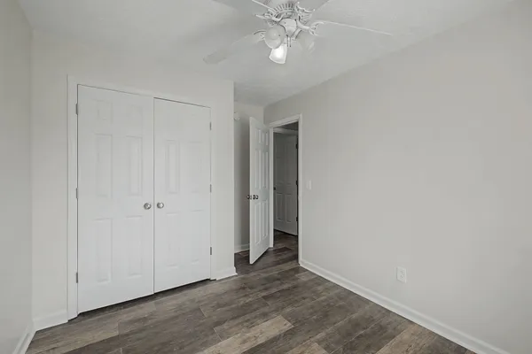 a view of an empty room with wooden floor