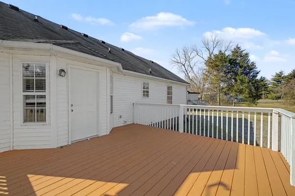 a view of backyard with a deck