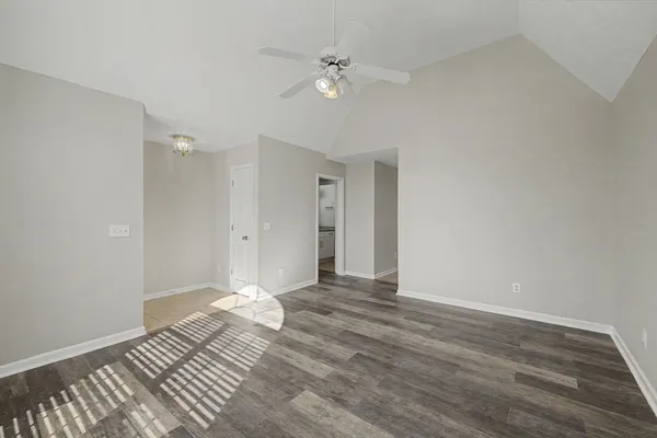 a view of an empty room with wooden floor