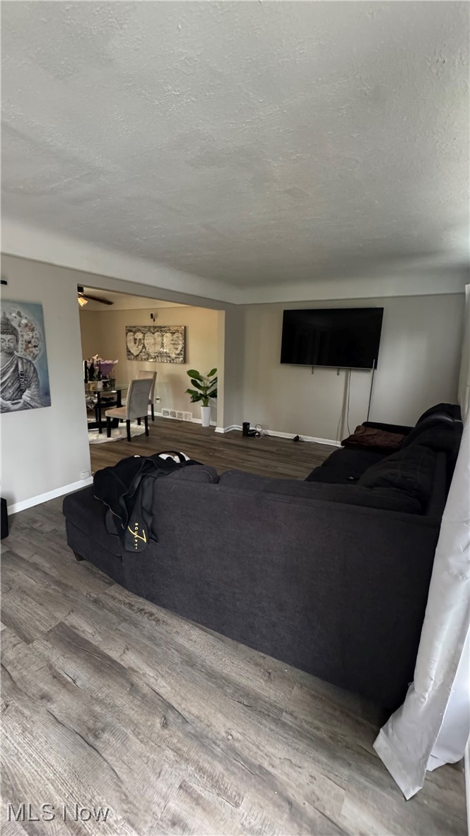 2110 Alton Road Cleveland, OH 44112 - Photo 2 of 27 Living room featuring a textured ceiling, wood finished floors, and baseboards