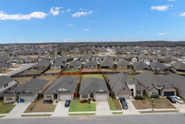 an aerial view of multiple houses with yard