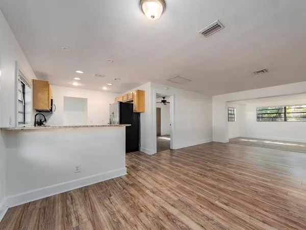 a view of kitchen with furniture and wooden floor