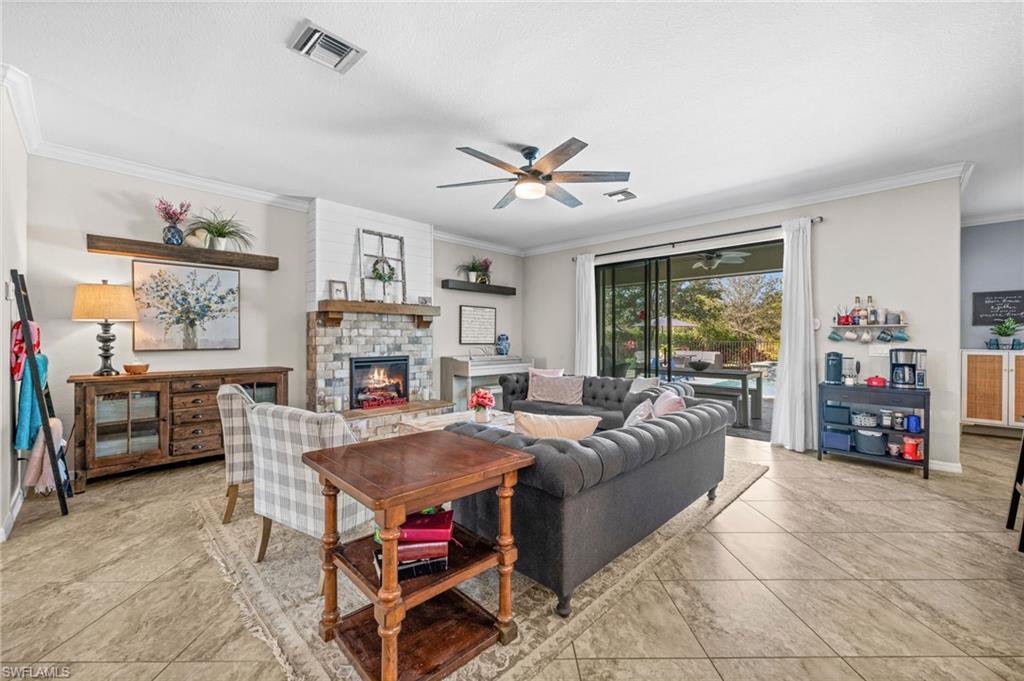 4754 Abaca Circle Naples, FL 34119 - Photo 5 of 46 a living room with furniture and a fireplace