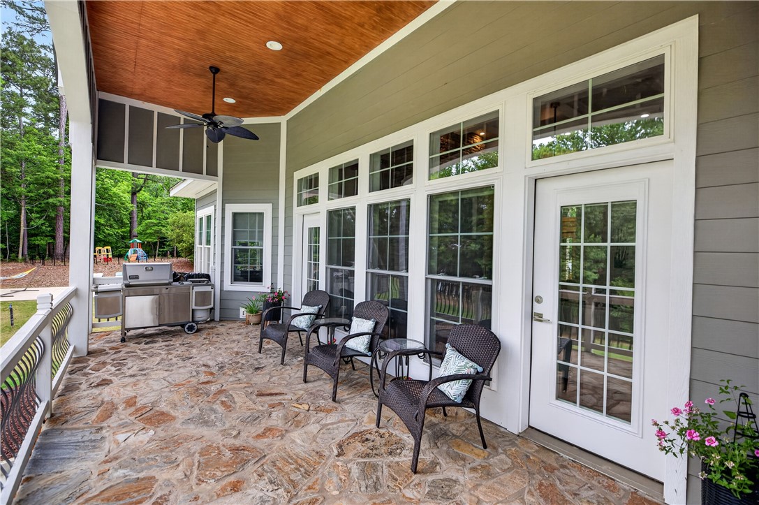 206 James Hare Road Anderson, SC 29626 - Photo 23 of 37 A spacious covered patio with natural stone flooring offers an ideal spot for outdoor enjoyment.