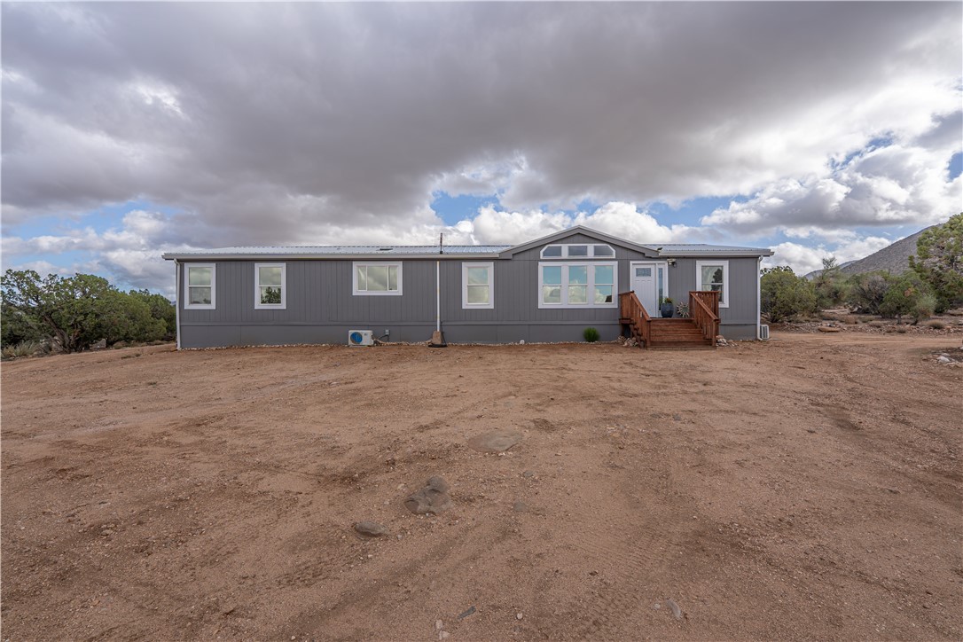 2765 North Silver Springs Road Kingman, AZ 86401 - Photo 8 of 60 a front view of house with yard and trees around