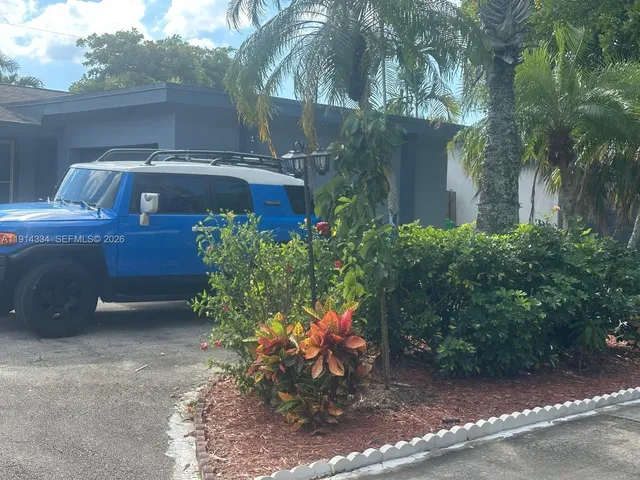 a view of a chairs and table in the backyard