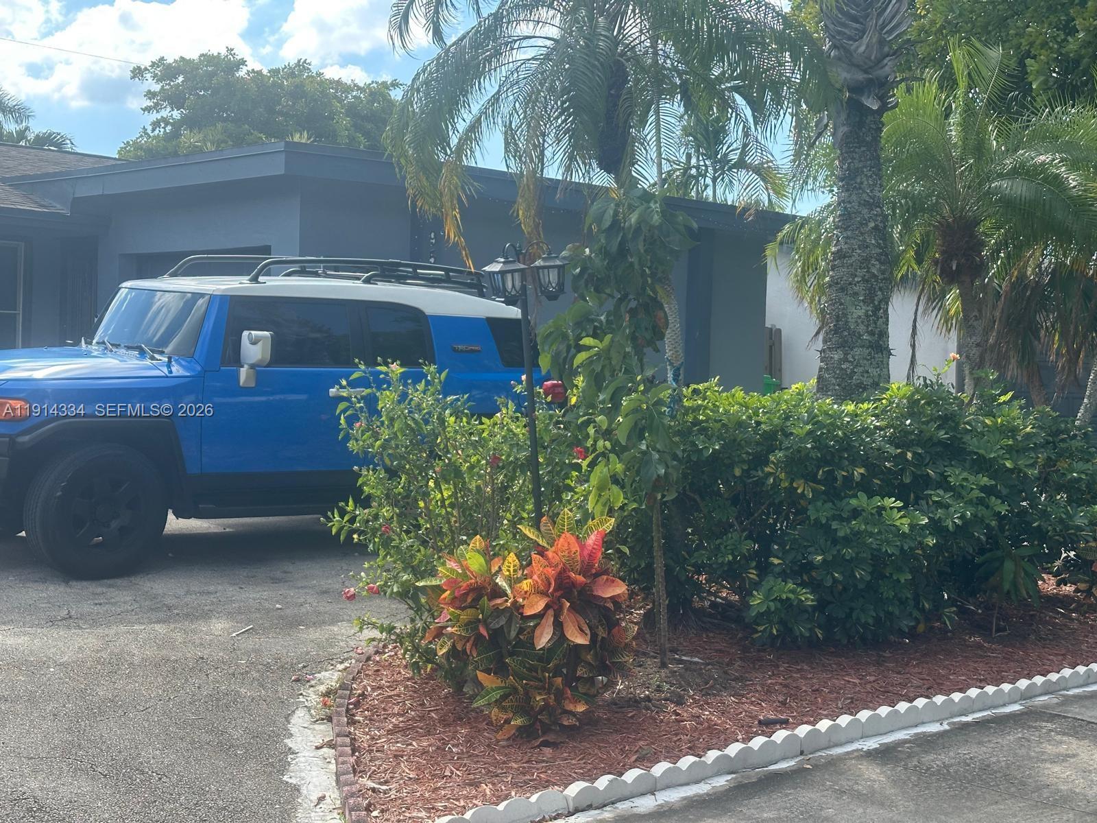 a view of a chairs and table in the backyard