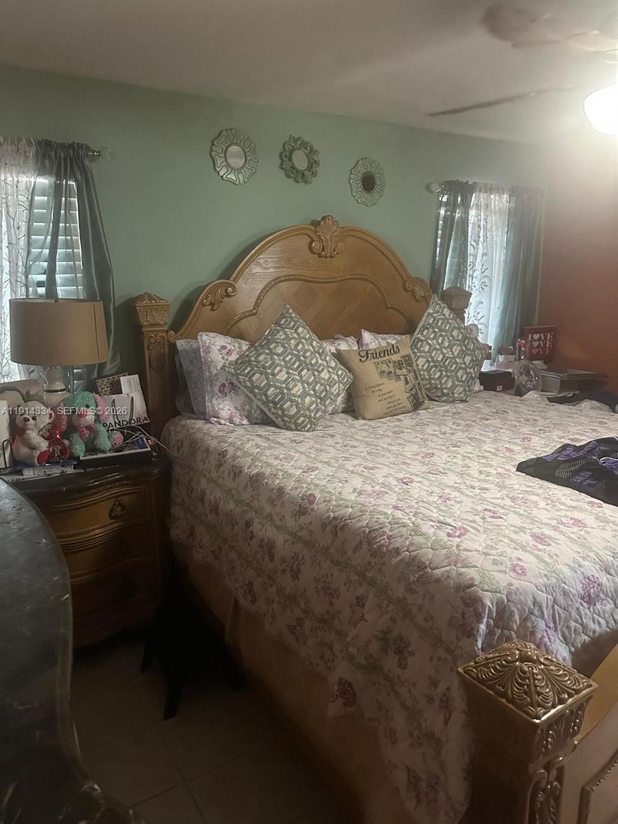 9530 Sunset Strip Sunrise, FL 33322 - Photo 4 of 11 a bedroom with a bed and a dresser