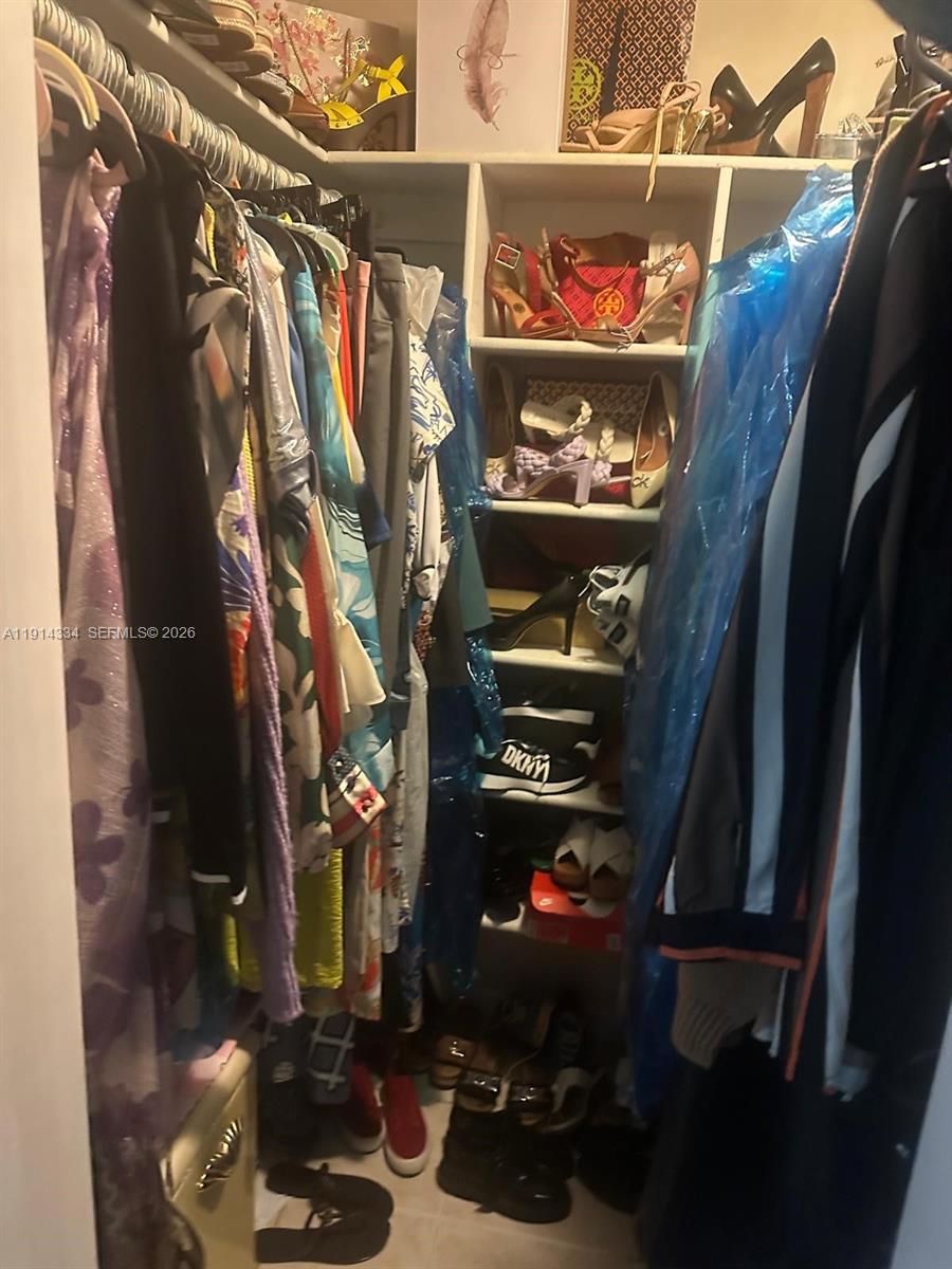 9530 Sunset Strip Sunrise, FL 33322 - Photo 5 of 11 a view of walk in closet with clothes and shoes