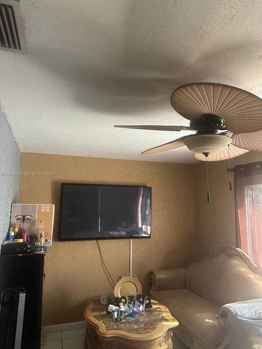 9530 Sunset Strip Sunrise, FL 33322 - Photo 6 of 11 a living room with furniture and a chandelier