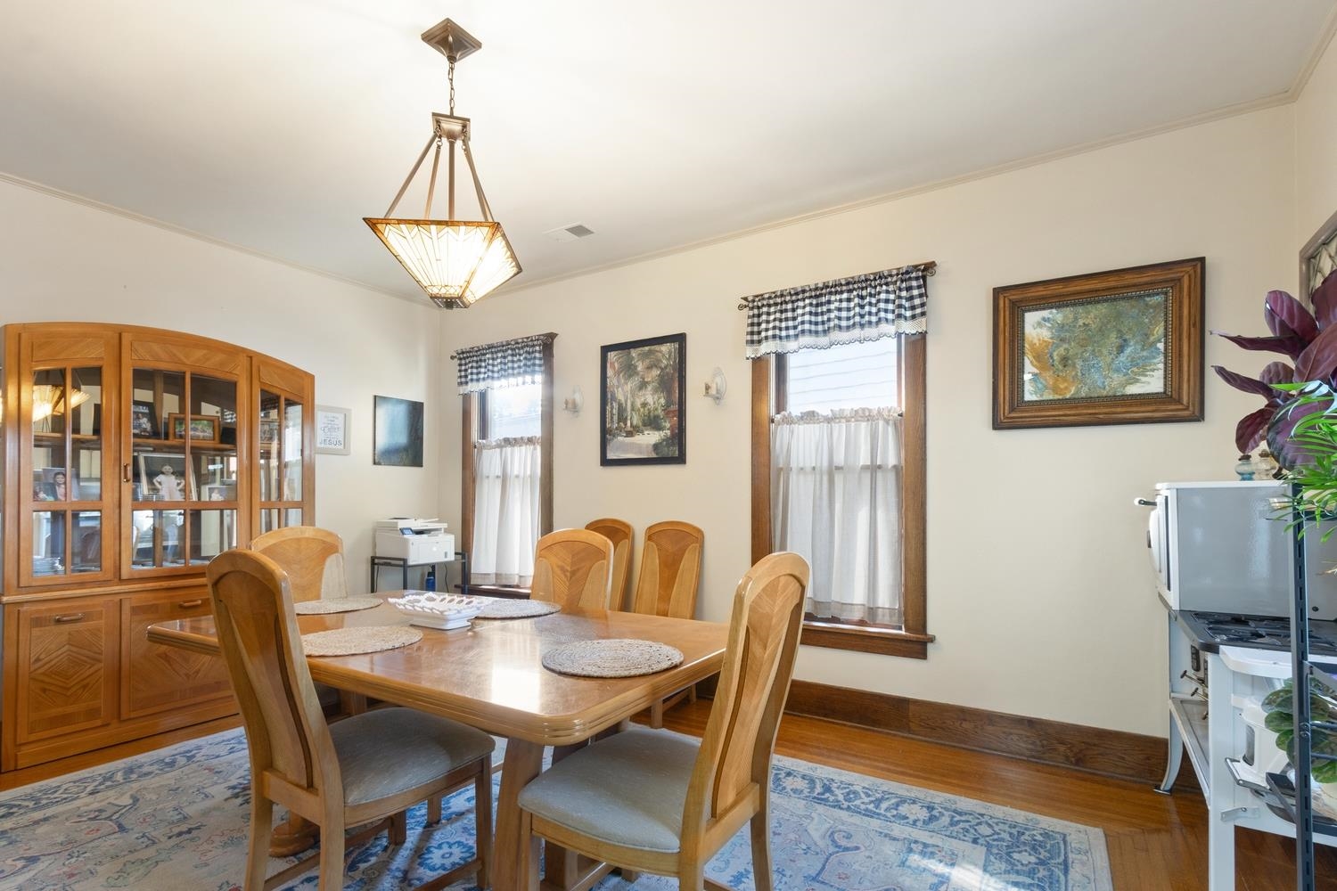 804 Locust Street Sterling, IL 61081 - Photo 11 of 25 a dining room with furniture a chandelier and wooden floor