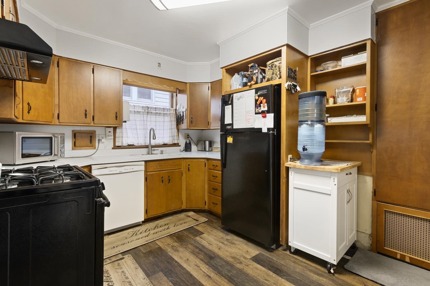 804 Locust Street Sterling, IL 61081 - Photo 12 of 25 a kitchen with a refrigerator and a stove top oven