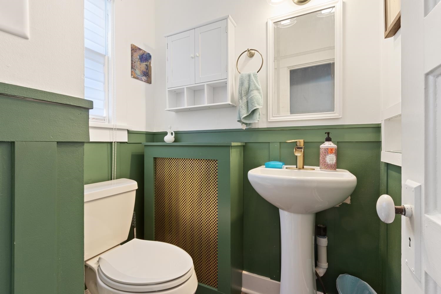 804 Locust Street Sterling, IL 61081 - Photo 14 of 25 a bathroom with a sink toilet and mirror