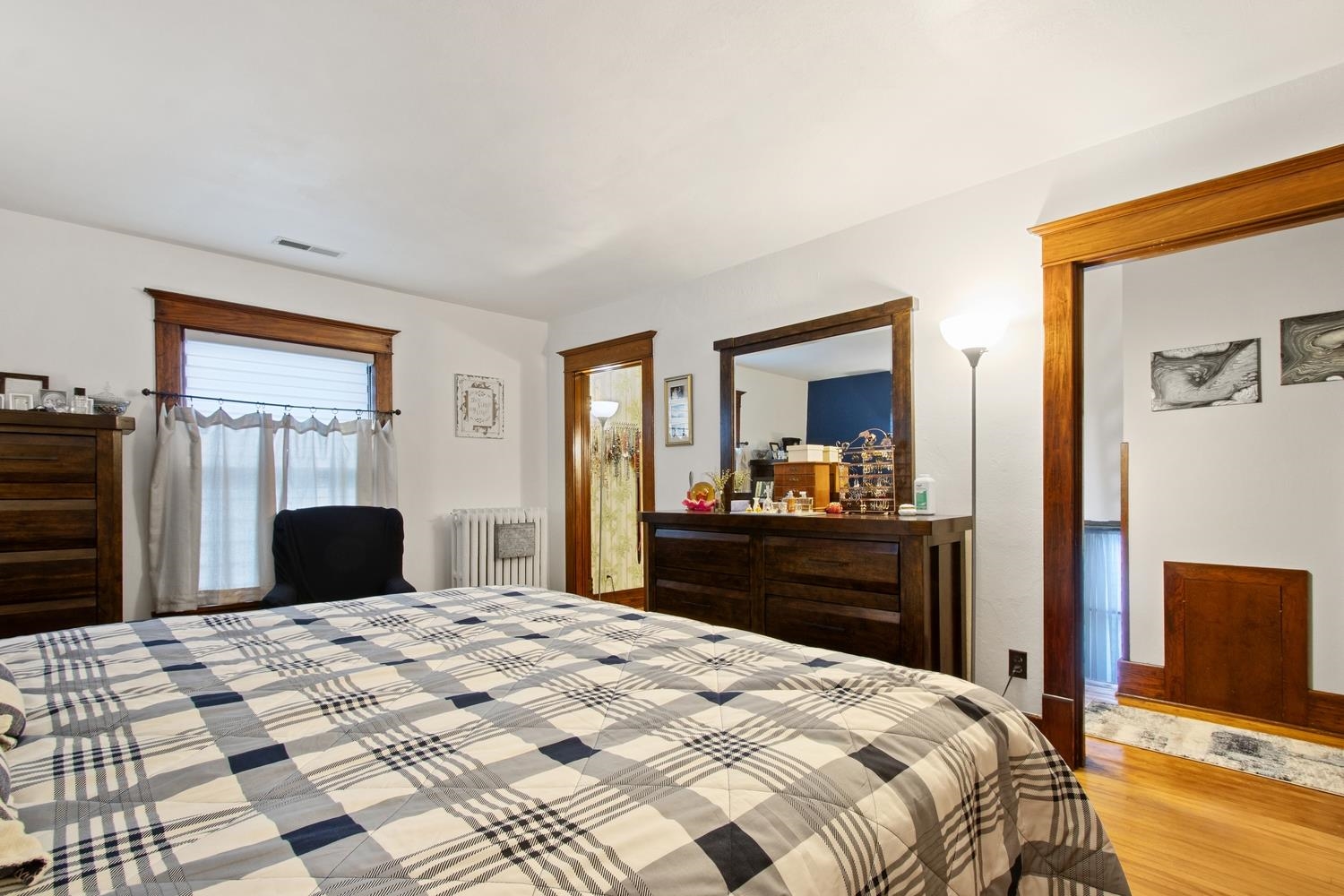 804 Locust Street Sterling, IL 61081 - Photo 17 of 25 a bedroom with a bed and a dresser next to a window