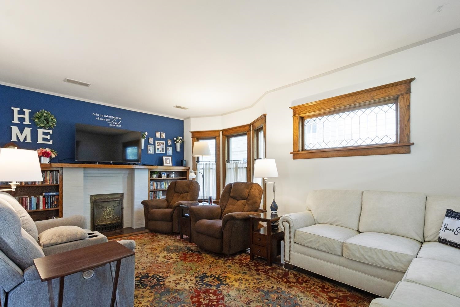 804 Locust Street Sterling, IL 61081 - Photo 9 of 25 a living room with furniture a fireplace and a large window