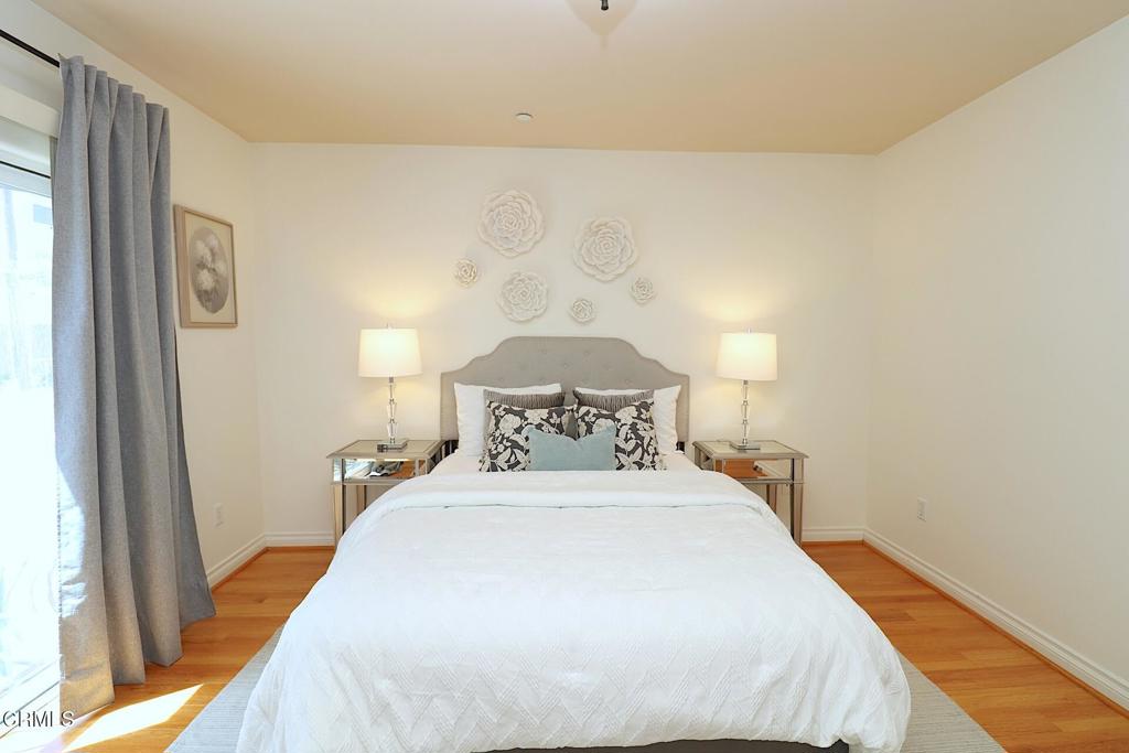 3855 Ingraham Street, Unit 204 Los Angeles, CA 90005 - Photo 14 of 35 a bedroom with a bed and a large mirror