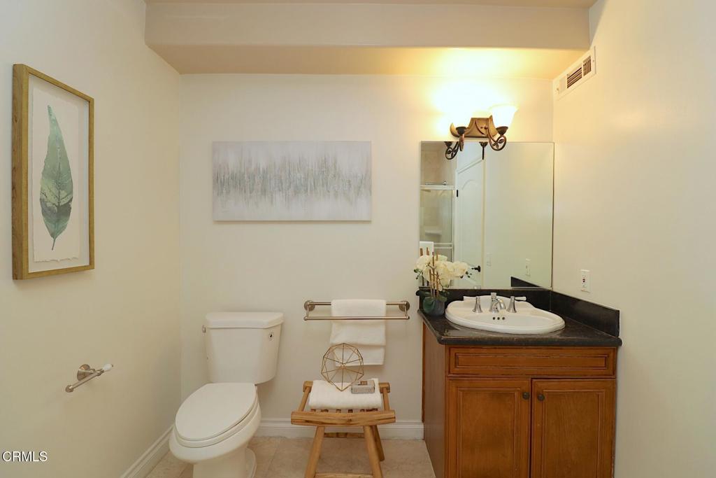 3855 Ingraham Street, Unit 204 Los Angeles, CA 90005 - Photo 19 of 35 a bathroom with a sink toilet and a mirror