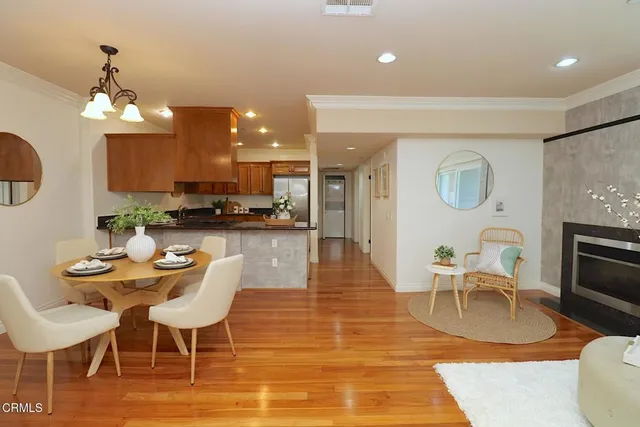 a living room with furniture a dining table and kitchen view