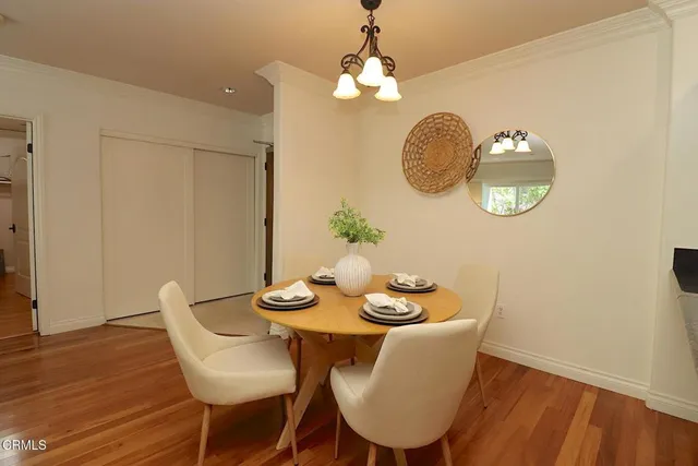 a view of a dining room with furniture wooden floor and chandelier