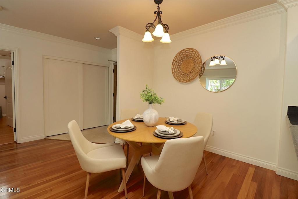3855 Ingraham Street, Unit 204 Los Angeles, CA 90005 - Photo 5 of 35 a view of a dining room with furniture wooden floor and chandelier