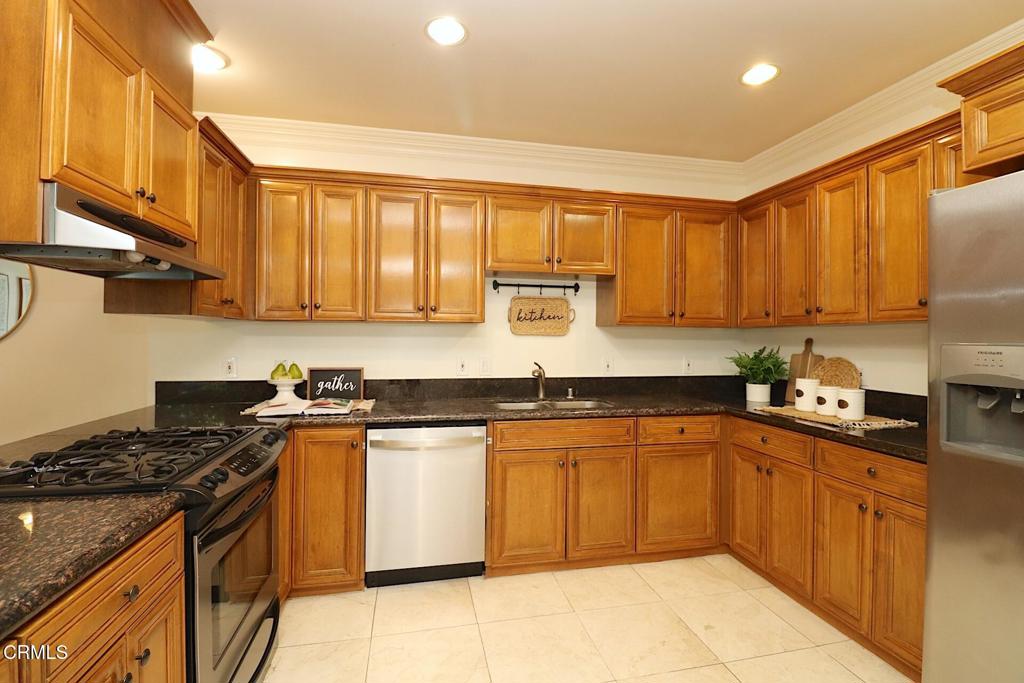 3855 Ingraham Street, Unit 204 Los Angeles, CA 90005 - Photo 6 of 35 a kitchen with stainless steel appliances granite countertop a stove a sink dishwasher and a refrigerator