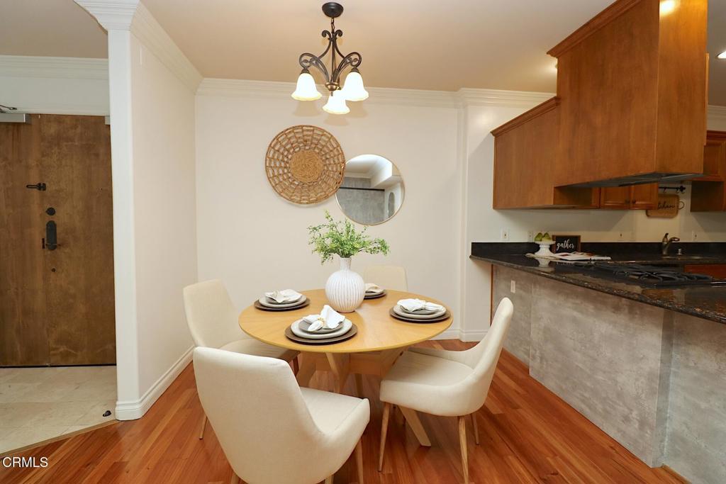 3855 Ingraham Street, Unit 204 Los Angeles, CA 90005 - Photo 7 of 35 a view of a dining room with furniture and chandelier