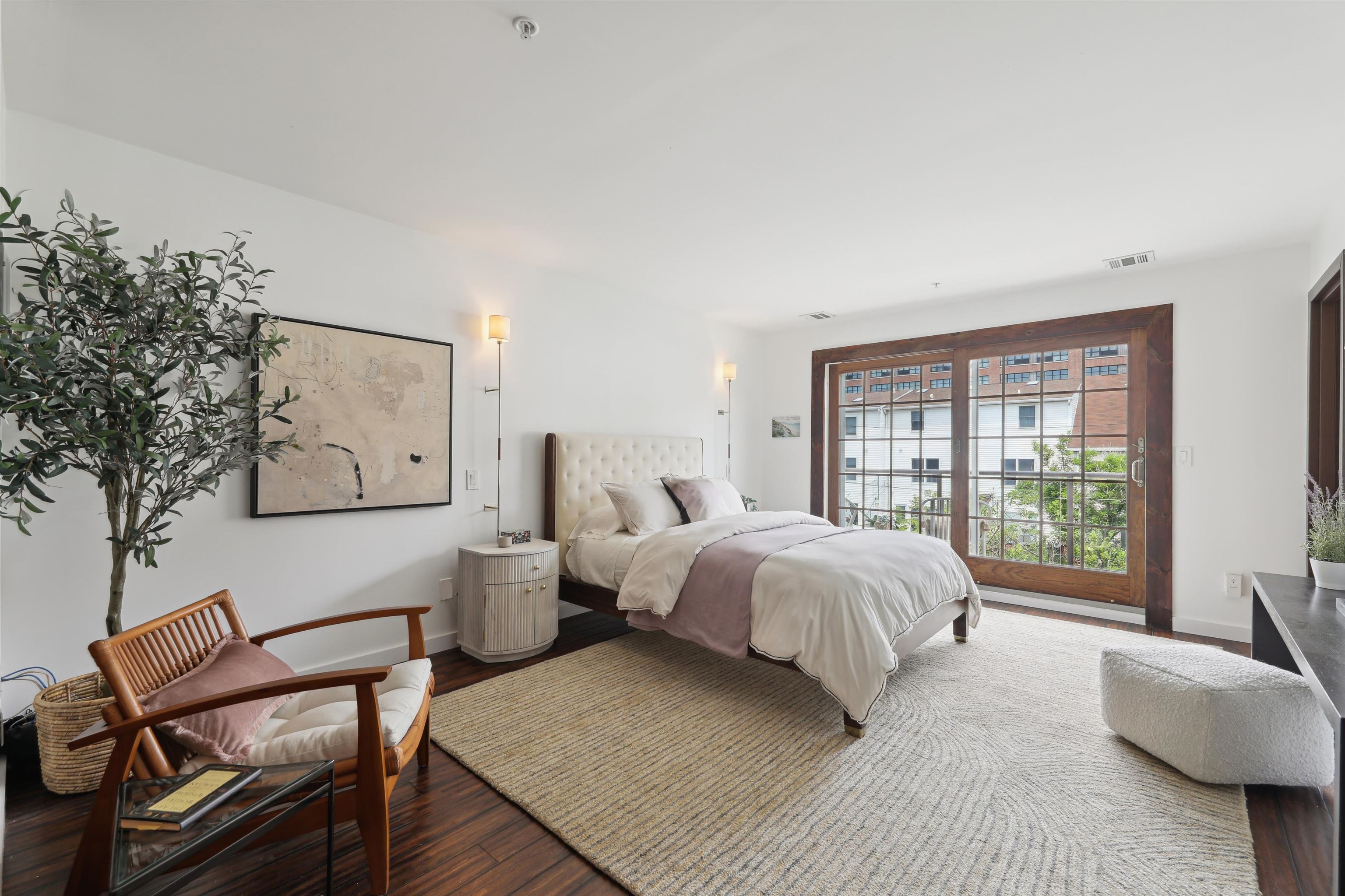 310 9th Street Jersey City, NJ 07302 - Photo 15 of 34 a spacious bedroom with a bed and glass window