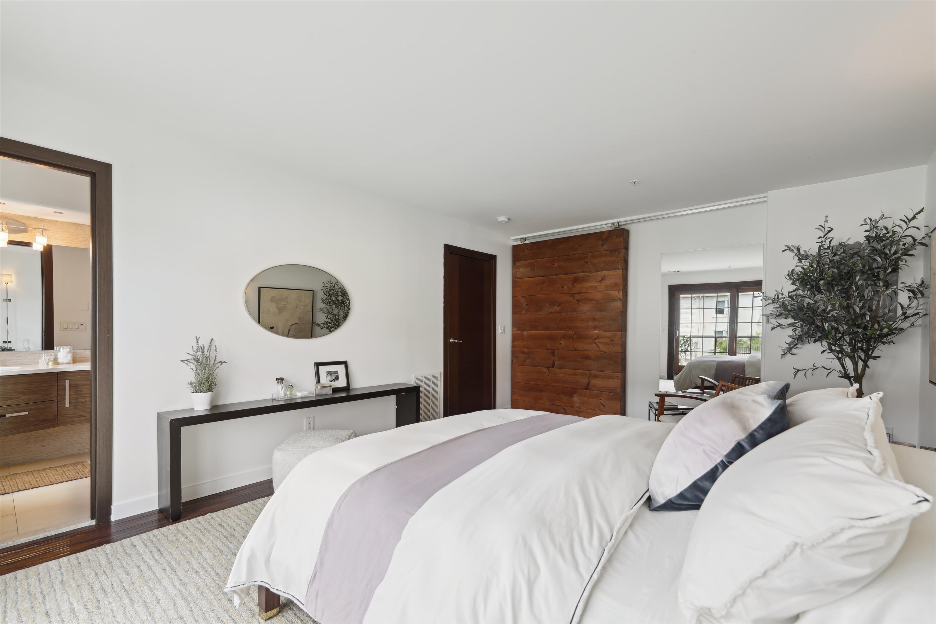 310 9th Street Jersey City, NJ 07302 - Photo 16 of 34 a bedroom with a large bed and a large mirror