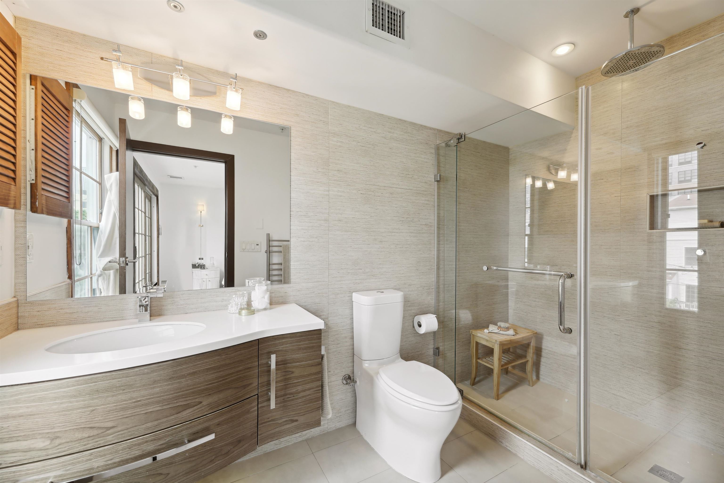 310 9th Street Jersey City, NJ 07302 - Photo 18 of 34 a bathroom with a double vanity sink toilet and shower