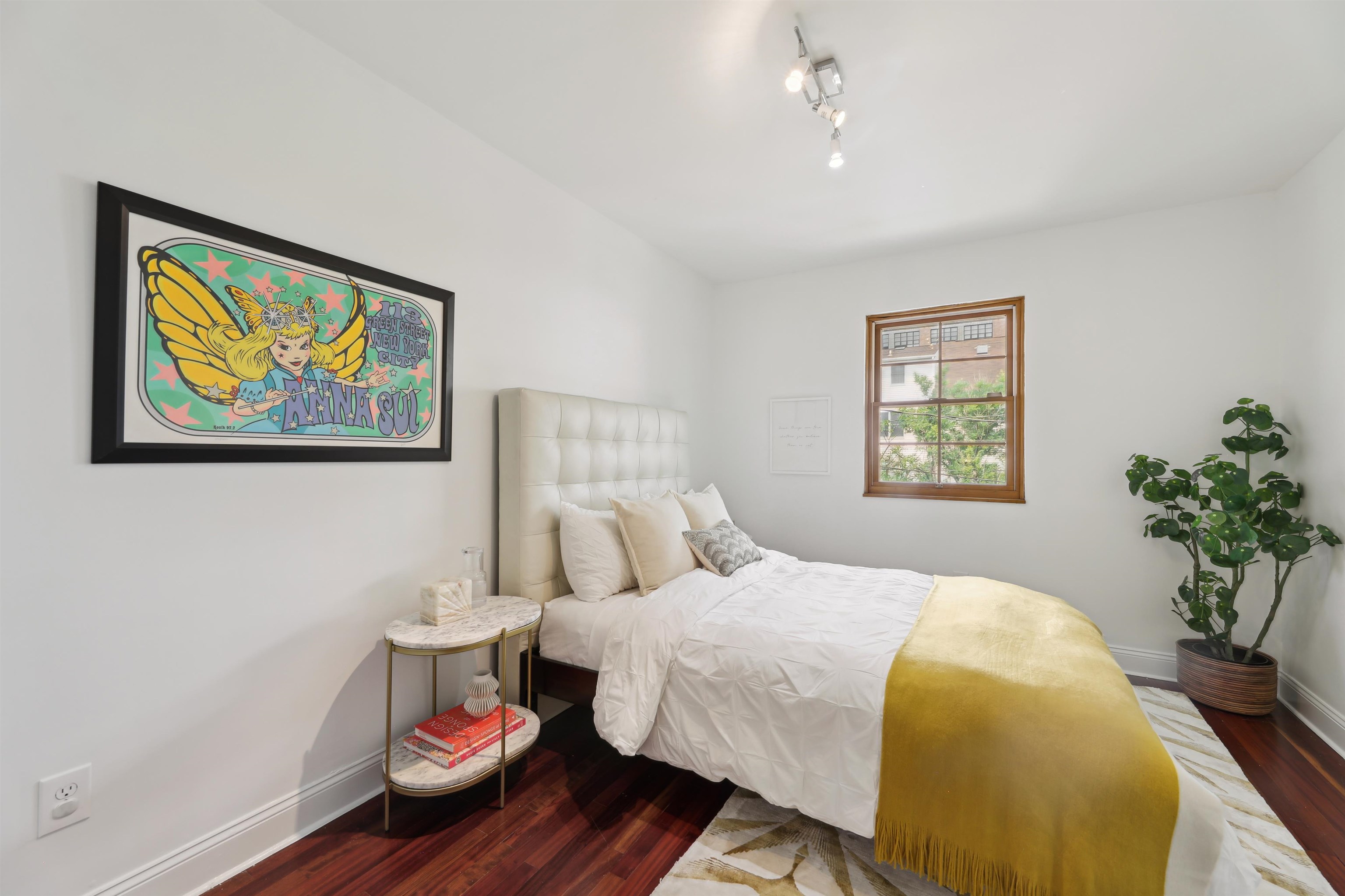 310 9th Street Jersey City, NJ 07302 - Photo 22 of 34 a bedroom with a bed and a painting on the wall