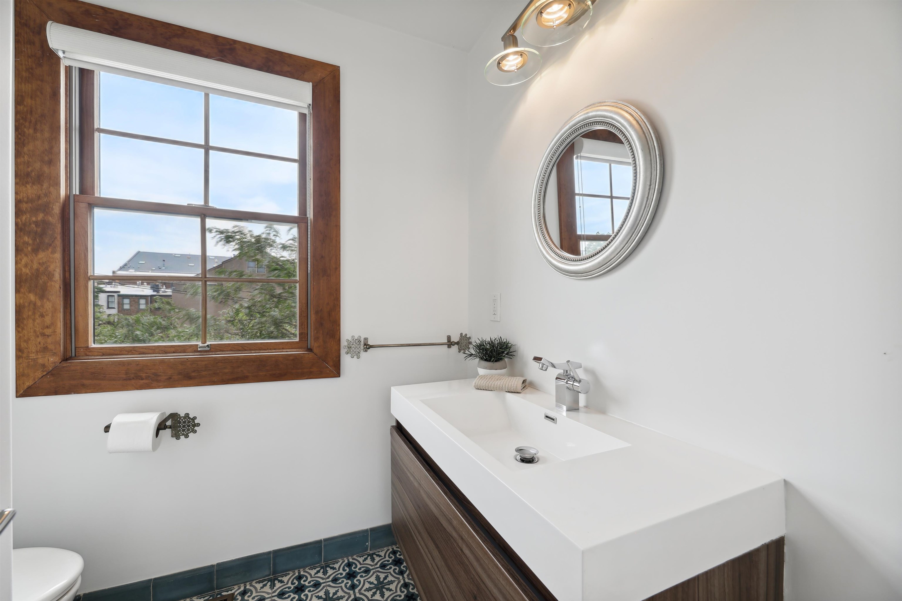 310 9th Street Jersey City, NJ 07302 - Photo 25 of 34 a bathroom with a sink and a mirror