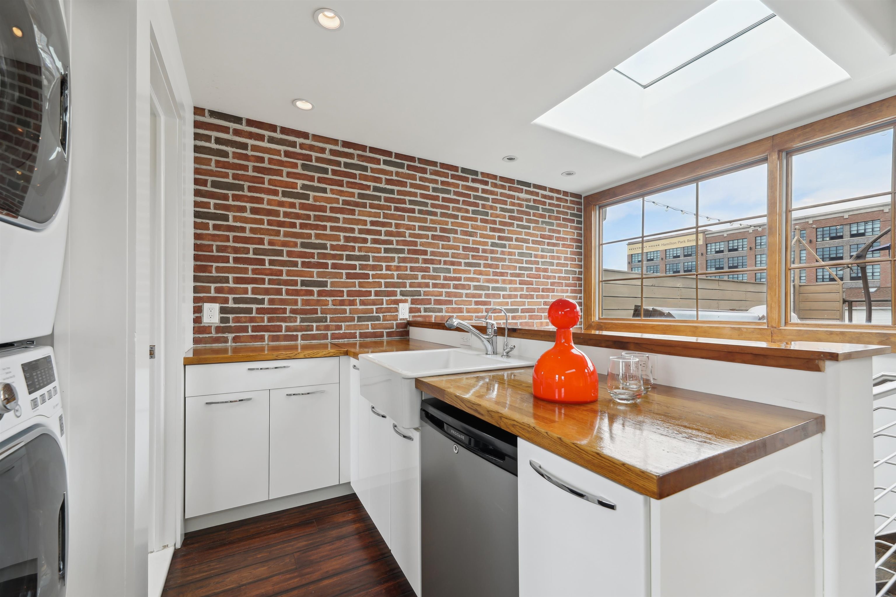 310 9th Street Jersey City, NJ 07302 - Photo 26 of 34 a kitchen with a sink cabinets and wooden floor