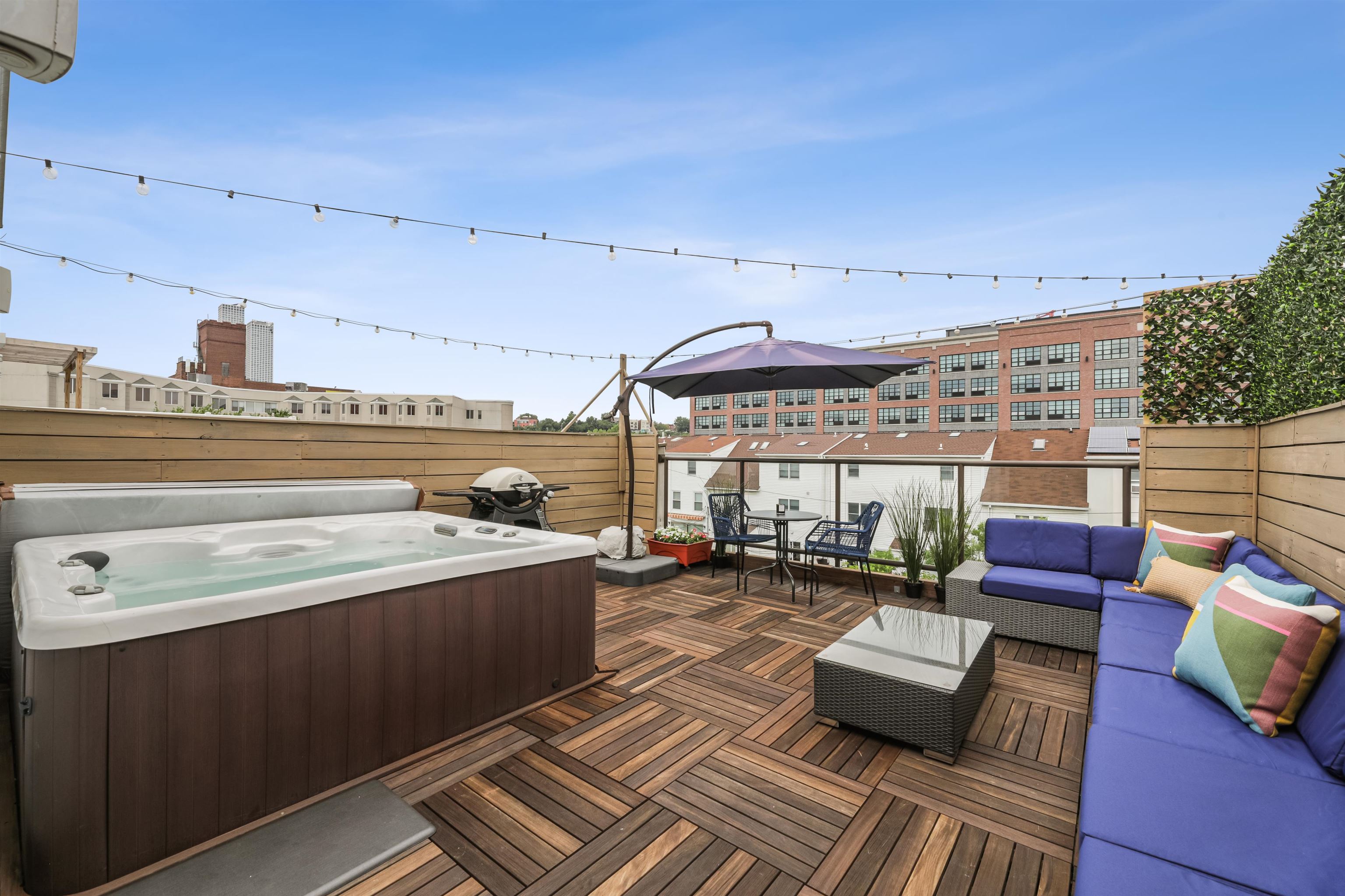 310 9th Street Jersey City, NJ 07302 - Photo 27 of 34 a roof deck with couches and wooden floor
