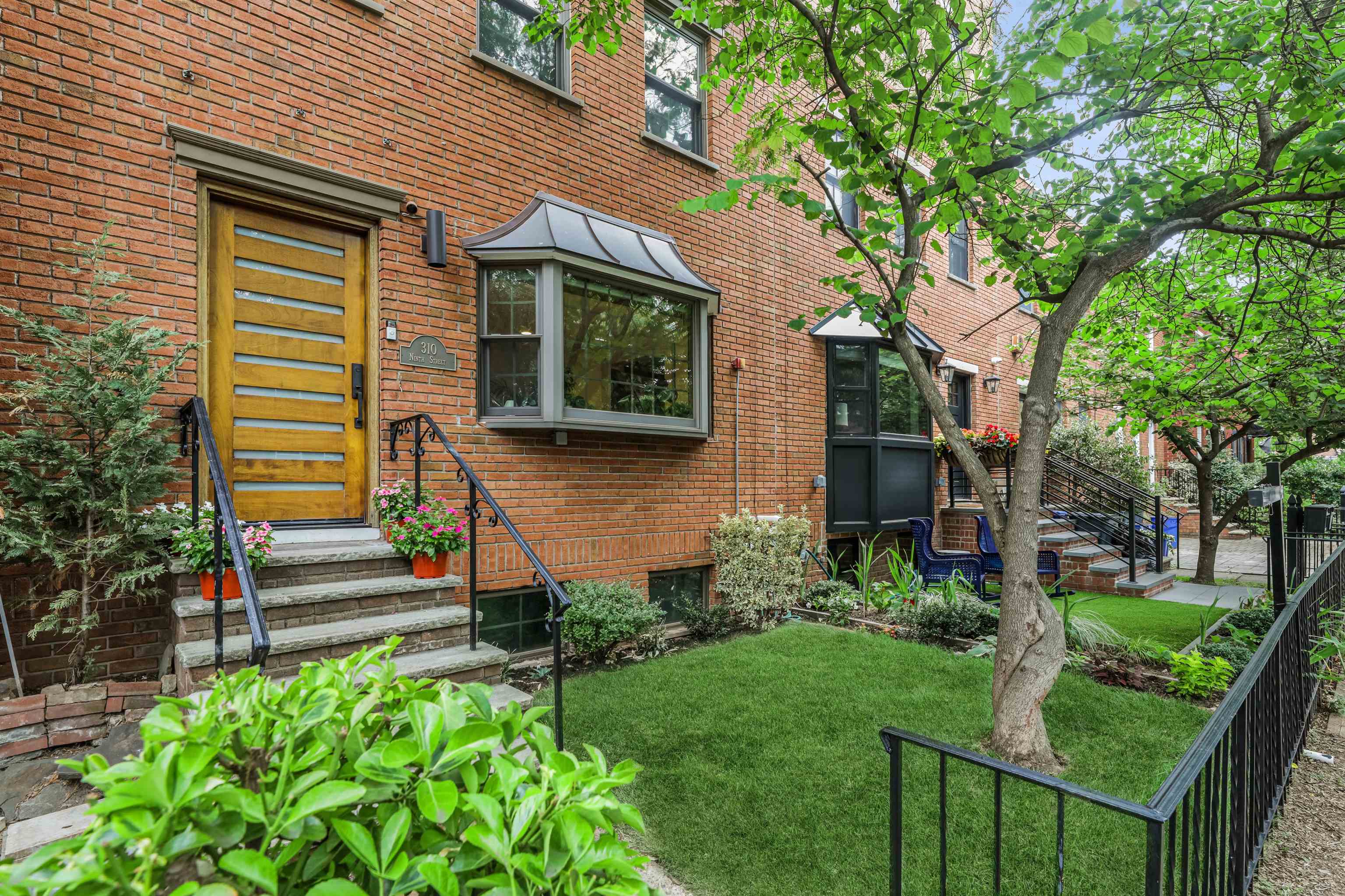 310 9th Street Jersey City, NJ 07302 - Photo 31 of 34 a front view of a house with garden