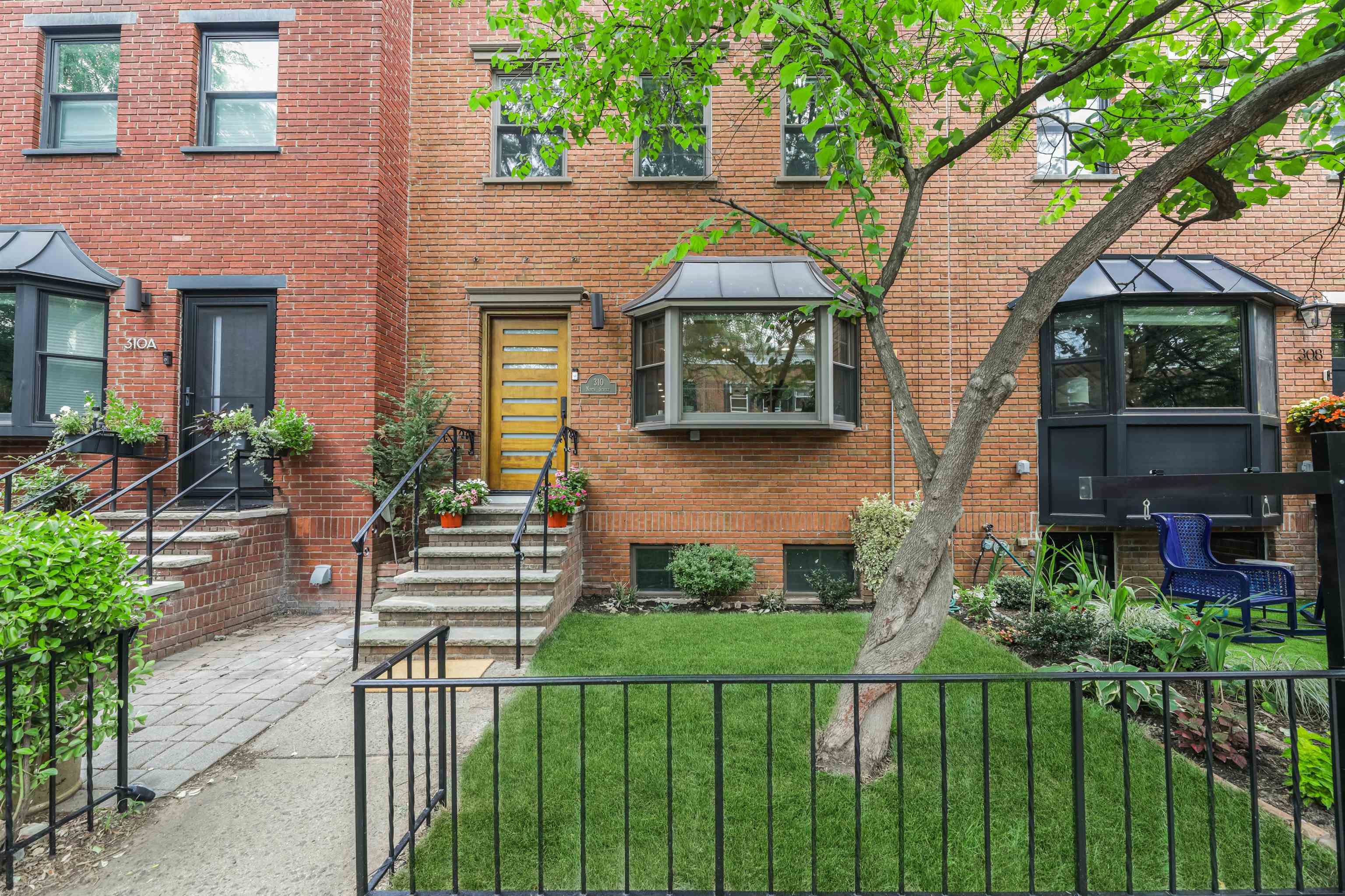 310 9th Street Jersey City, NJ 07302 - Photo 32 of 34 a front view of house and yard with green space