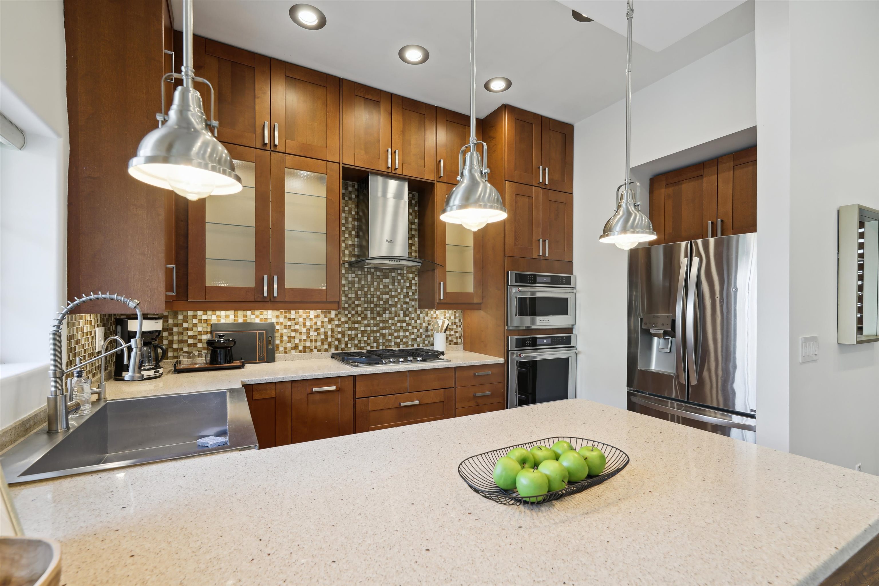 310 9th Street Jersey City, NJ 07302 - Photo 8 of 34 a kitchen with stainless steel appliances kitchen island a refrigerator and a sink