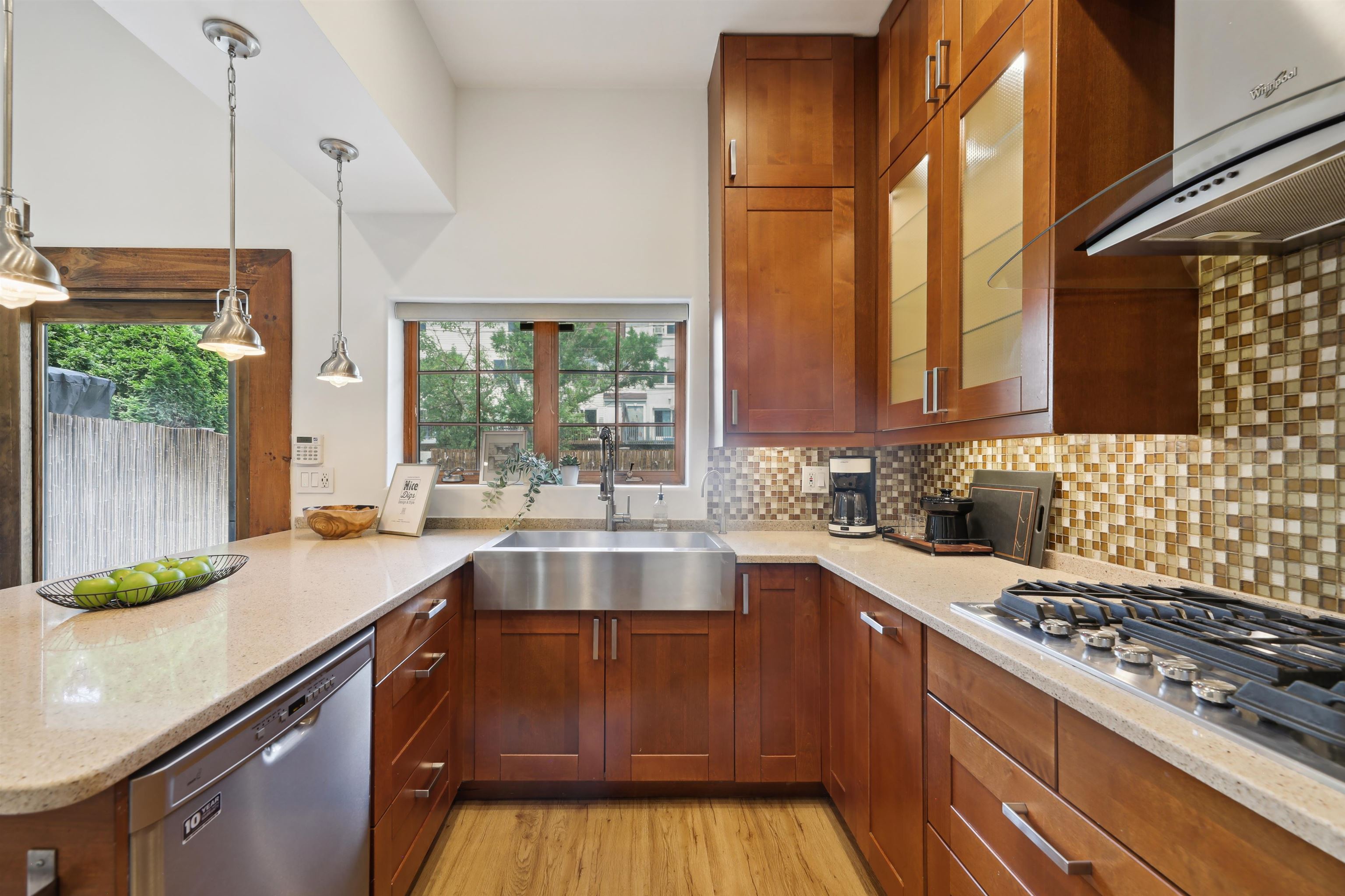 310 9th Street Jersey City, NJ 07302 - Photo 10 of 34 a kitchen with a sink a counter top space and stainless steel appliances