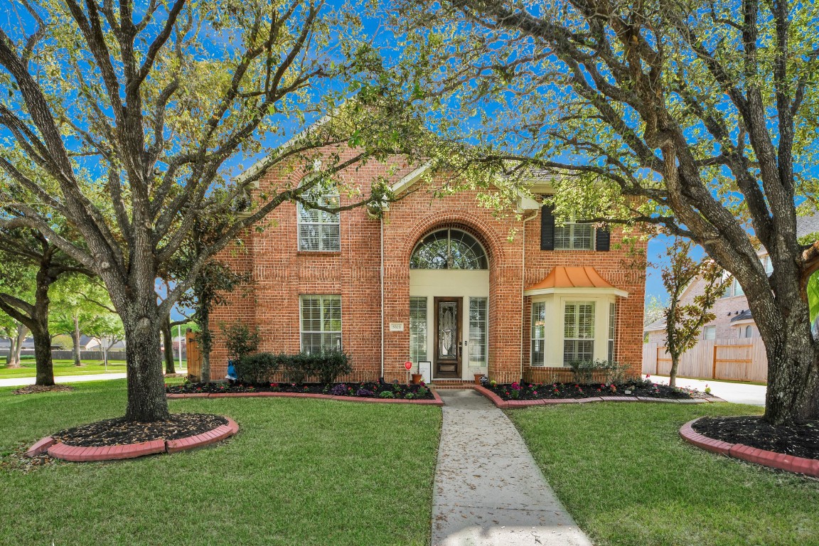 a front view of a house with a garden