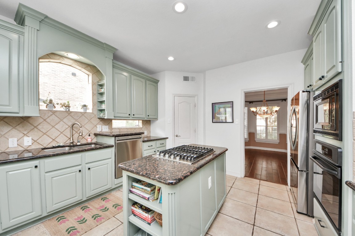 5703 Brennan Ridge Lane Katy, TX 77450 - Photo 15 of 45 a kitchen with stainless steel appliances granite countertop a stove and a sink