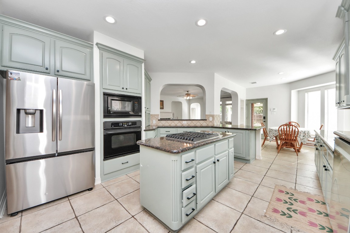 5703 Brennan Ridge Lane Katy, TX 77450 - Photo 16 of 45 a kitchen with stainless steel appliances granite countertop a stove a refrigerator and a refrigerator
