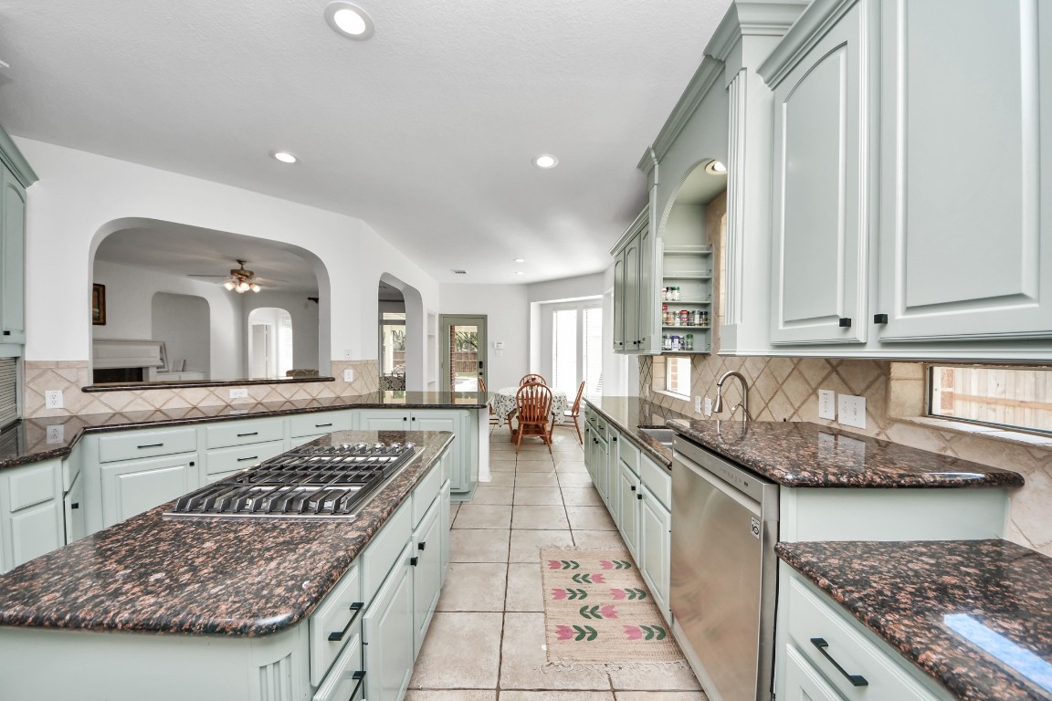 5703 Brennan Ridge Lane Katy, TX 77450 - Photo 17 of 45 a large kitchen with stainless steel appliances granite countertop a stove and a sink