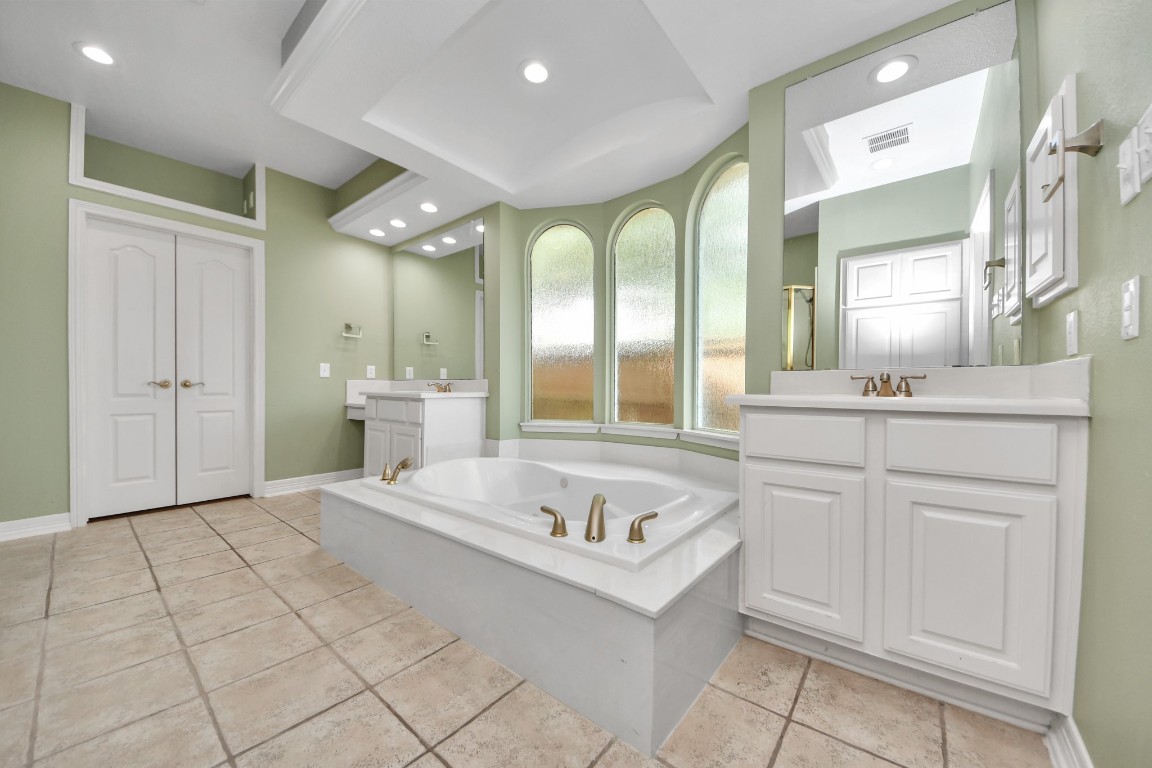 5703 Brennan Ridge Lane Katy, TX 77450 - Photo 26 of 45 a spacious bathroom with a double vanity sink and a mirror