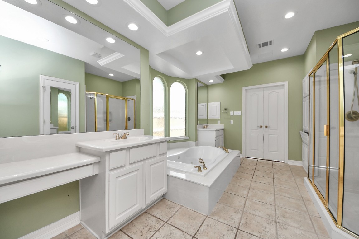 5703 Brennan Ridge Lane Katy, TX 77450 - Photo 28 of 45 a large bathroom with a large mirror vanity and shower