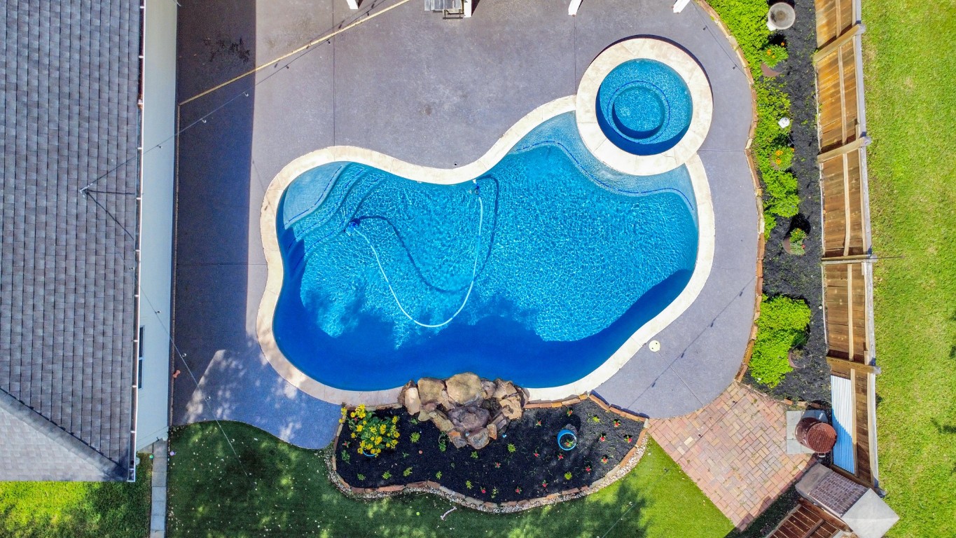 5703 Brennan Ridge Lane Katy, TX 77450 - Photo 3 of 45 a view of a swimming pool with a yard and plants