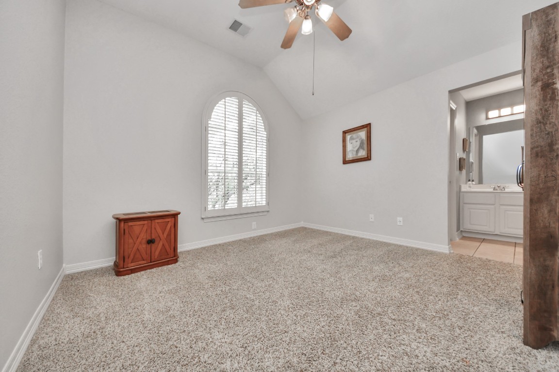 5703 Brennan Ridge Lane Katy, TX 77450 - Photo 31 of 45 an empty room with chandelier fan and windows