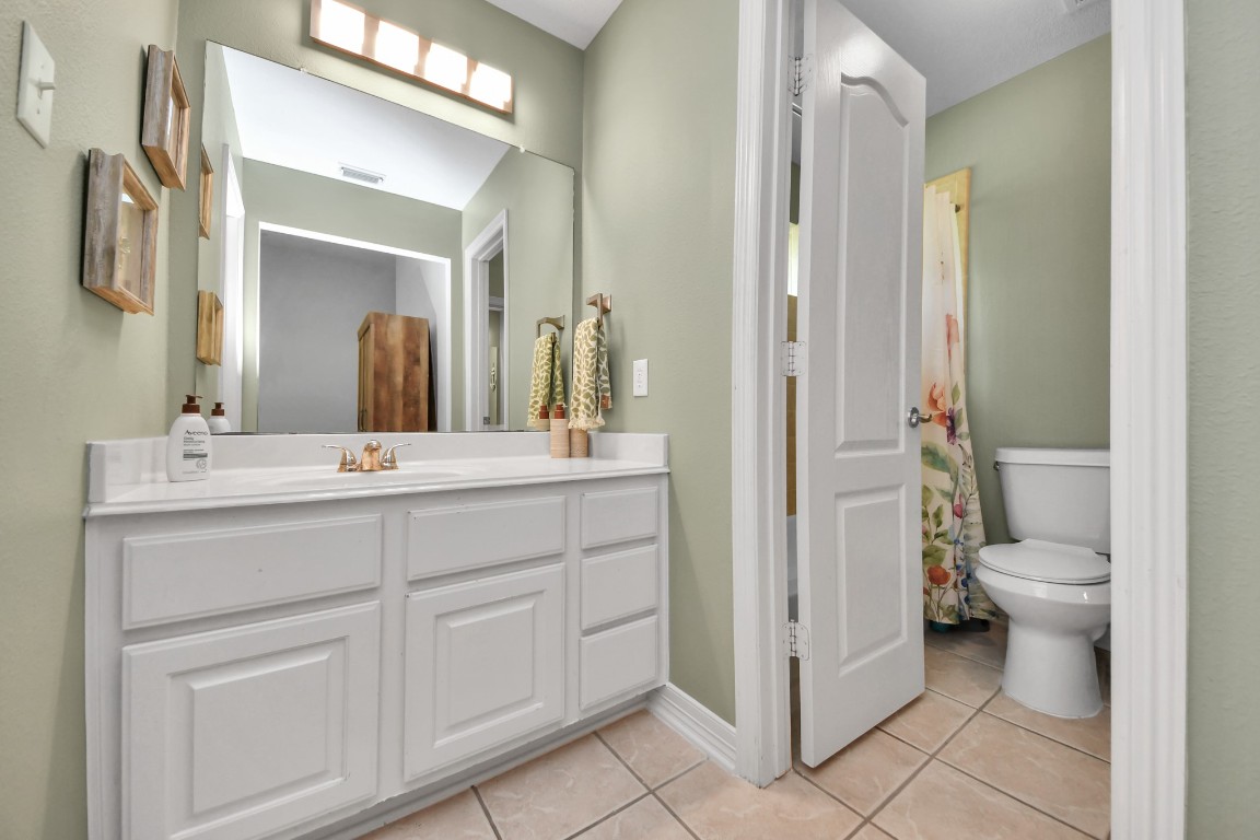 5703 Brennan Ridge Lane Katy, TX 77450 - Photo 32 of 45 a bathroom with a toilet sink and shower