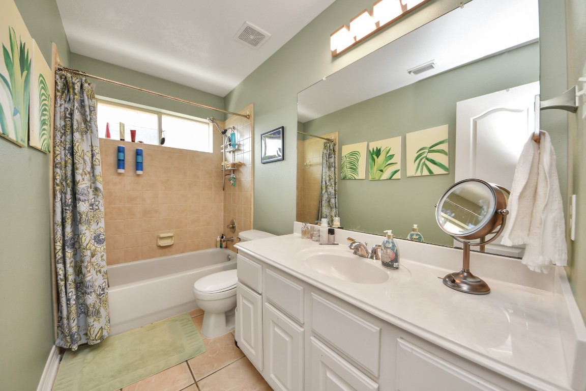 5703 Brennan Ridge Lane Katy, TX 77450 - Photo 37 of 45 a bathroom with a double vanity sink toilet mirror and bathtub